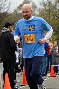 A colon cancer survivor crosses the finish line at the Winston-Salem race in March 2011.