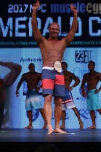 Doug on stage at a bodybuilding competition.