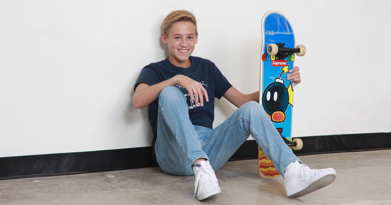 15-year-old Vinny with his skateboard.