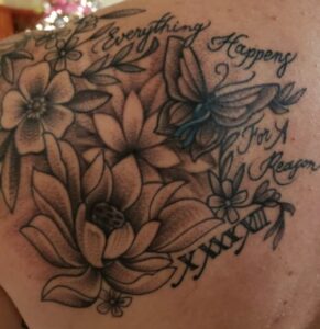 Jamie Dawson's Tattoo, script writing says "Everything Happens for a Reason" surrounding butterflies and flowers