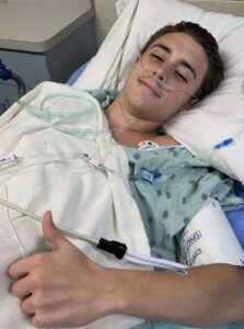 Jaystan gives a thumbs up after treatment/surgery for colon cancer