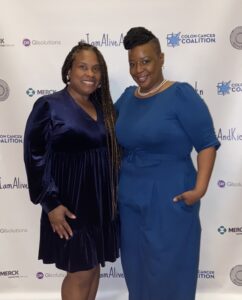 Dr. Liz at a fundraising gala with a friend. Both women dressed in blue.