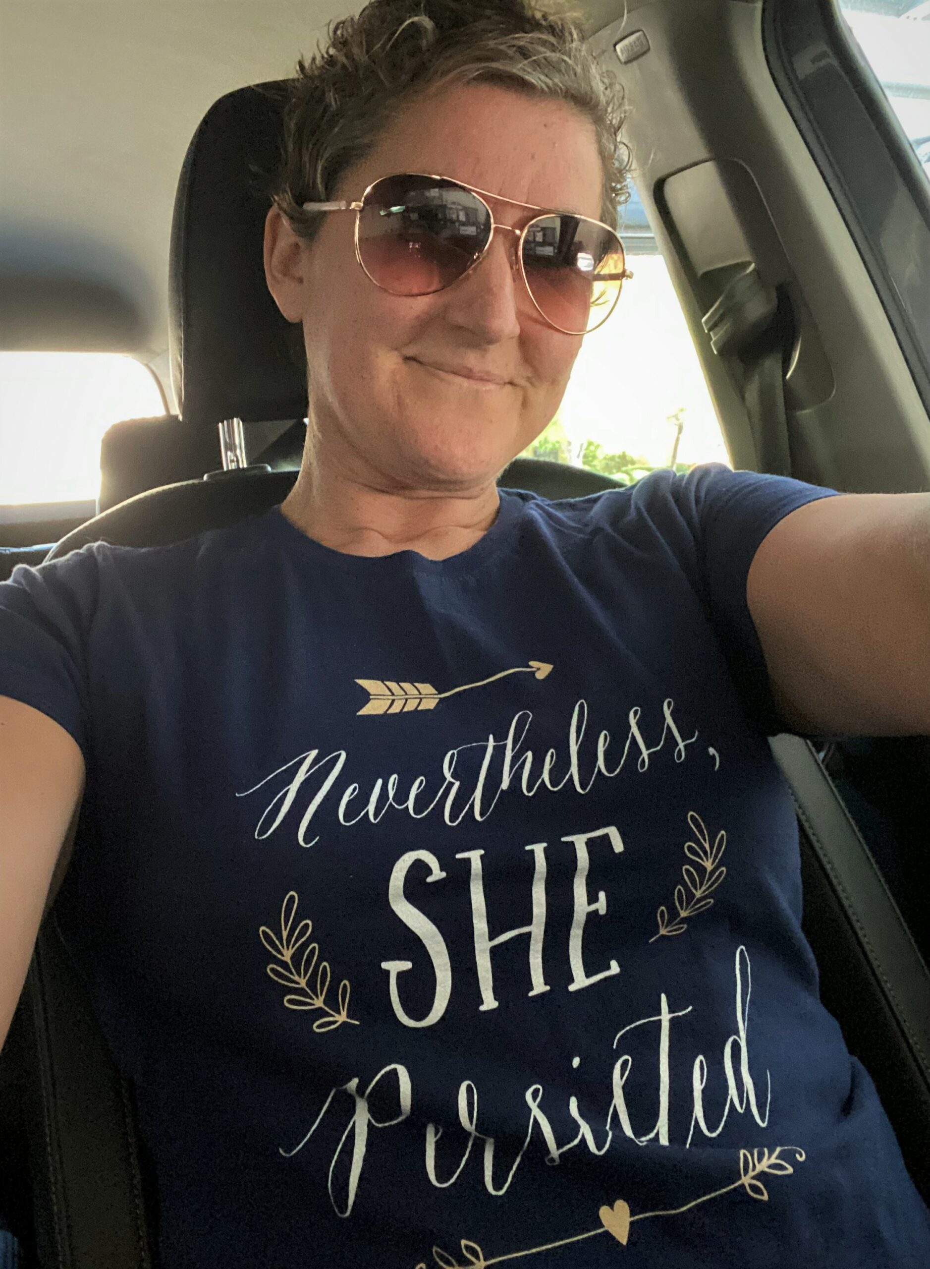 Reagan in car wearing a "Nevertheless, she persisted" T-shirt