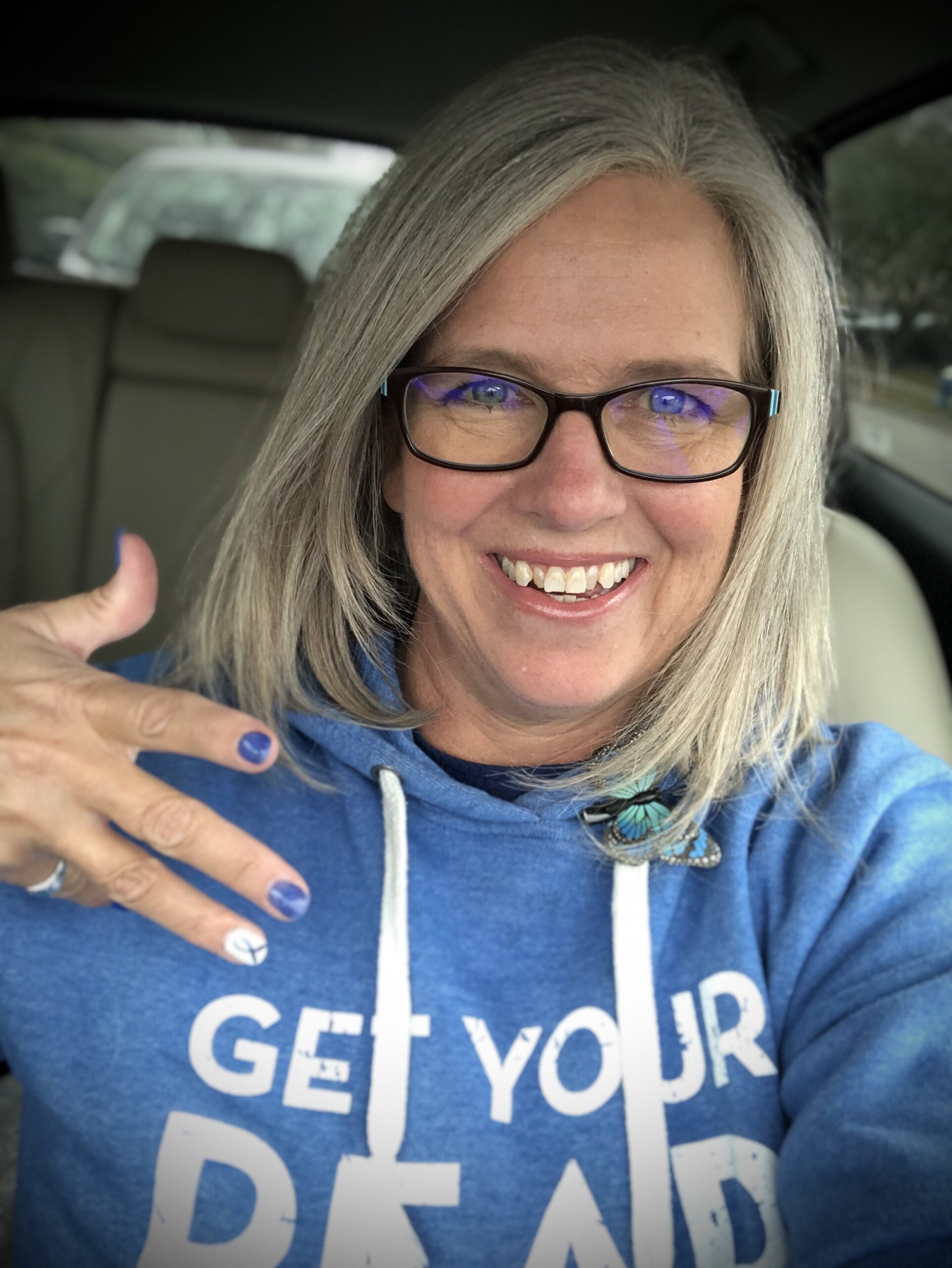 Laurie showing off her Colon Cancer Awareness nails and attire. 