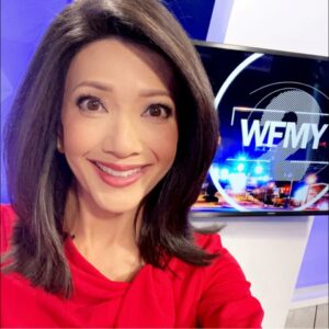 Julie Luck selfie in front of the WFMY TV Logo