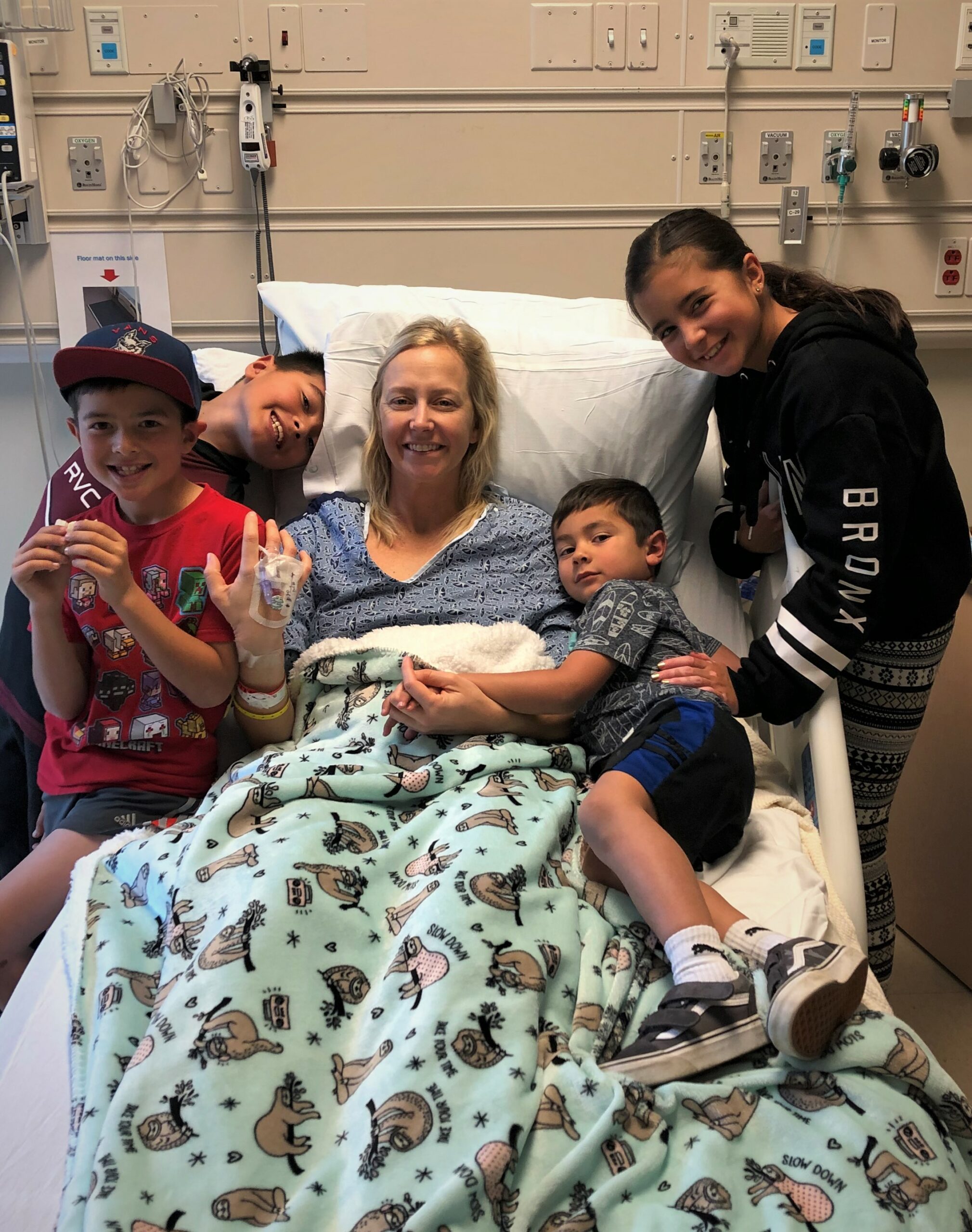 Erin embraces her children after her first surgery.